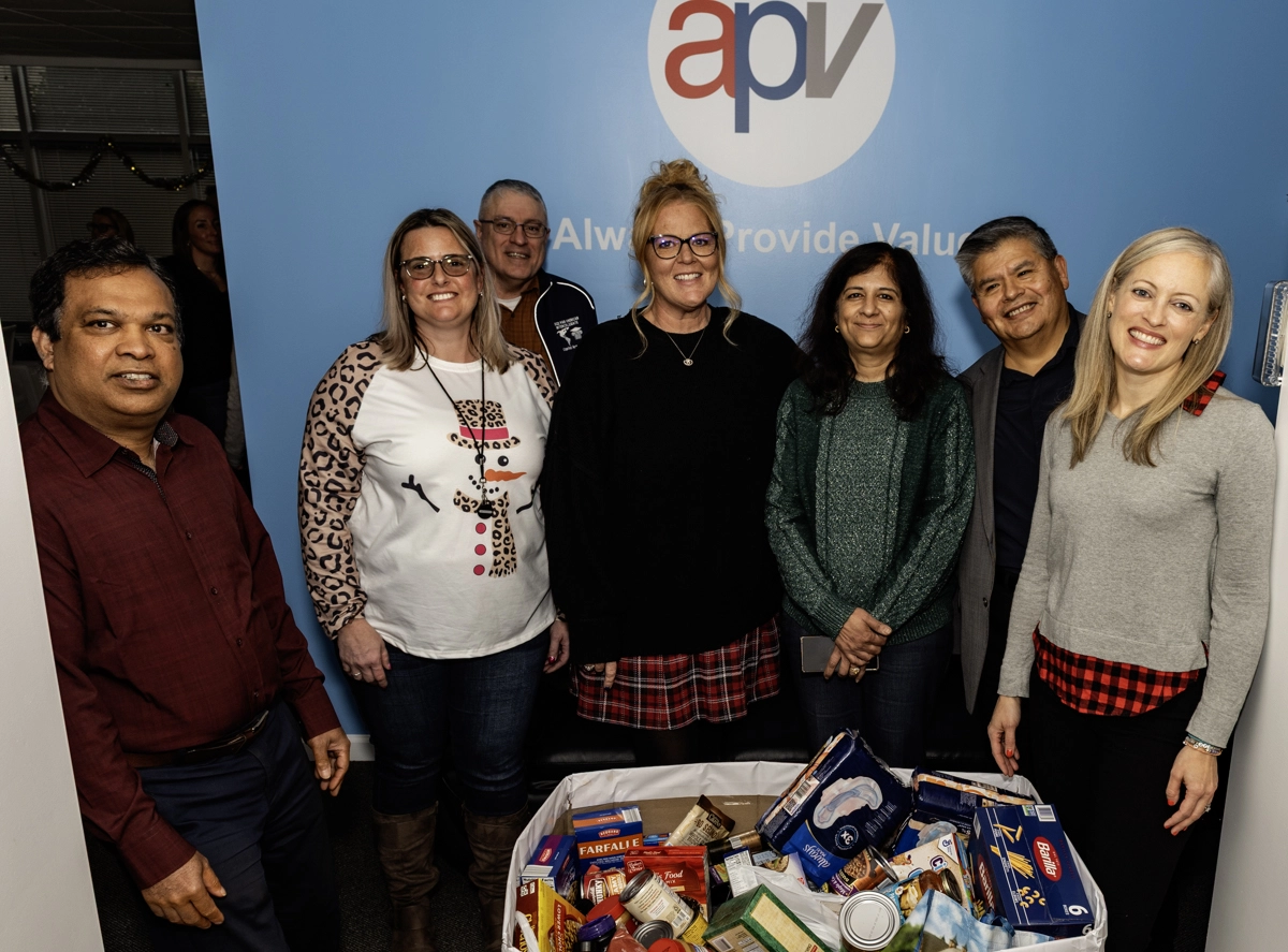 apvit team posing for a pic at an event